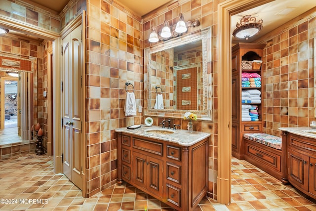 bathroom with tile walls, tile patterned floors, and vanity