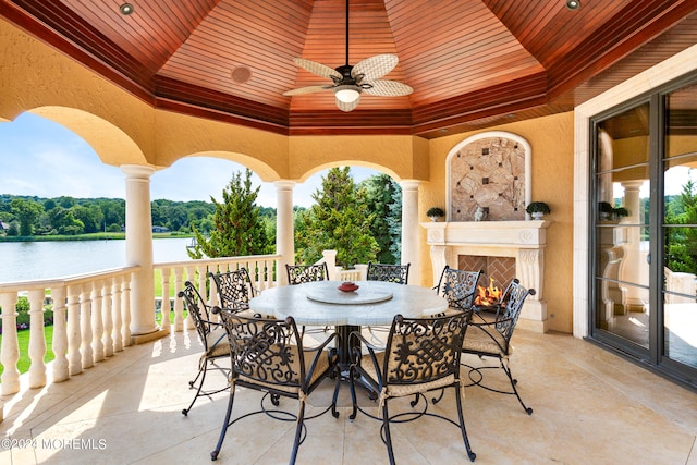 view of patio / terrace with ceiling fan and a water view