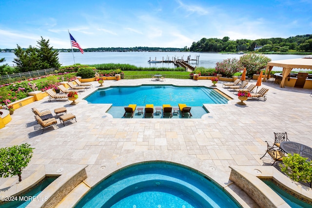 view of pool featuring an in ground hot tub and a patio