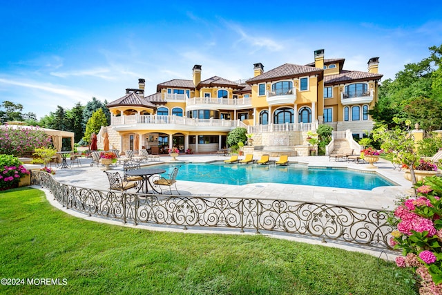 view of pool featuring a patio area and a lawn