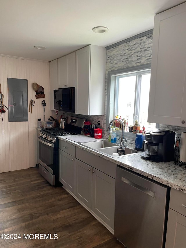 kitchen featuring sink, dark wood-type flooring, electric panel, and stainless steel appliances