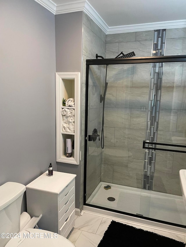 bathroom featuring tile patterned flooring, toilet, a shower with shower door, and ornamental molding