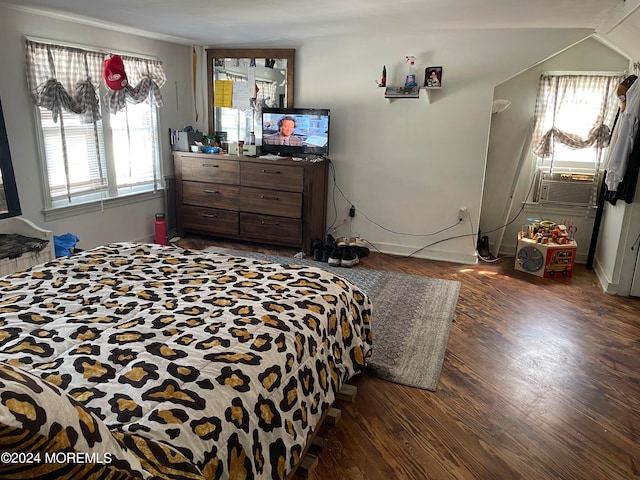 bedroom featuring dark wood-type flooring, cooling unit, and multiple windows