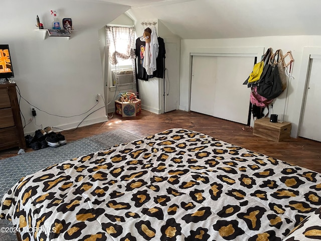 bedroom with a closet, vaulted ceiling, cooling unit, and dark hardwood / wood-style floors