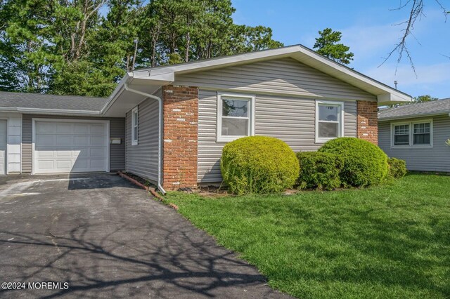 view of front of home with a front lawn and a garage