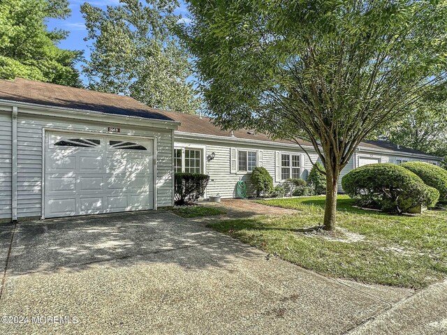 ranch-style house with a front yard and a garage