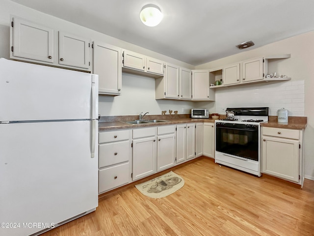 kitchen with light wood-type flooring, white cabinetry, white appliances, and sink