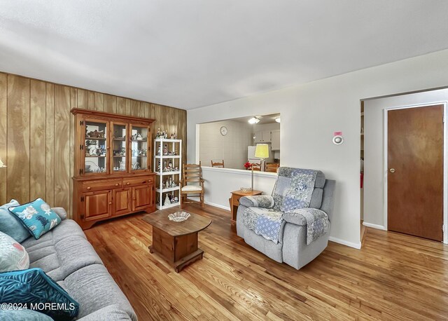 living room featuring wooden walls and light wood-type flooring