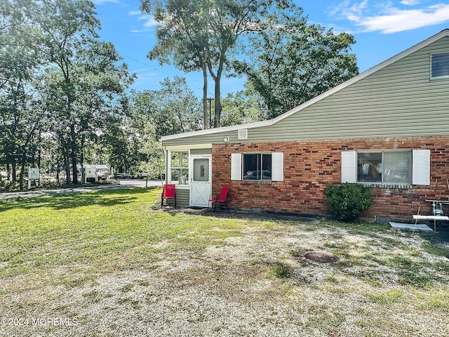 back of property featuring a yard