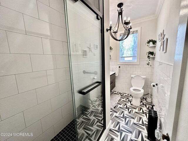 bathroom featuring a notable chandelier, tile walls, toilet, ornamental molding, and a stall shower