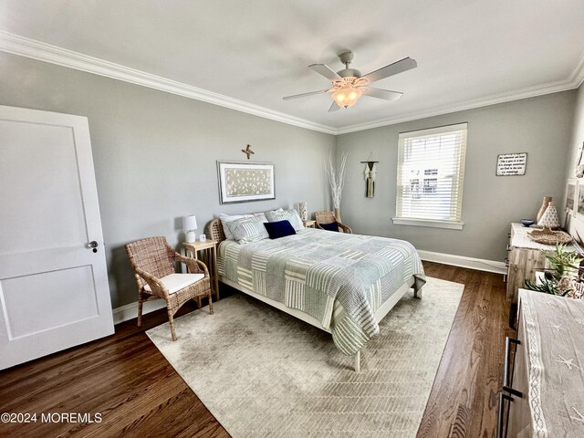 bedroom featuring dark wood-type flooring, crown molding, and baseboards