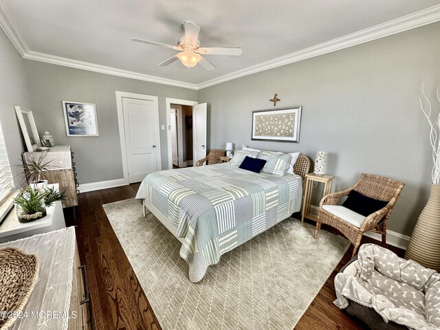 bedroom featuring ornamental molding, dark wood-style flooring, and baseboards