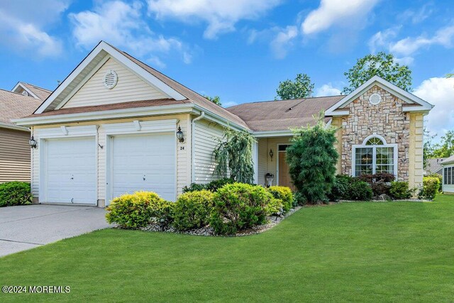 view of front facade with a garage and a front yard