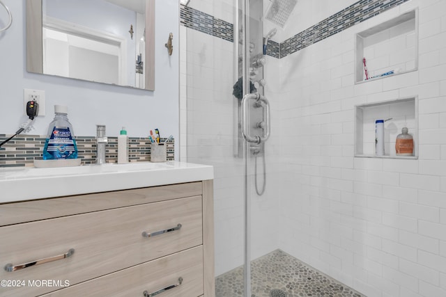 bathroom with an enclosed shower and vanity