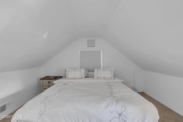 bedroom featuring carpet flooring and vaulted ceiling