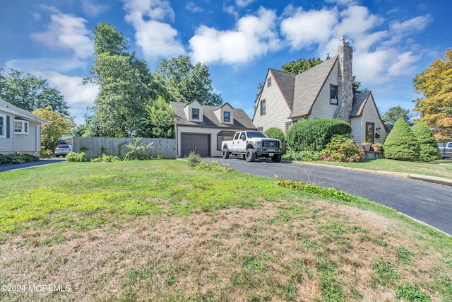 view of front of house featuring a garage and a front lawn