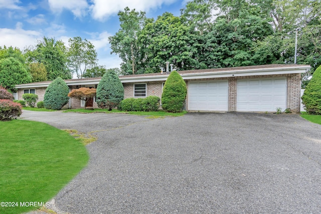 single story home with a front lawn and a garage