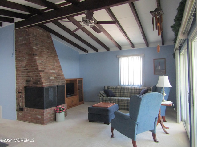 living room featuring carpet, a brick fireplace, vaulted ceiling with beams, and ceiling fan