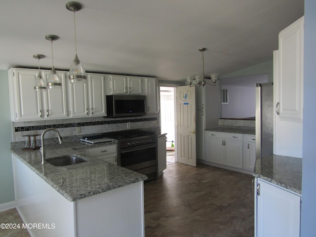 kitchen featuring sink, kitchen peninsula, decorative light fixtures, white cabinetry, and appliances with stainless steel finishes