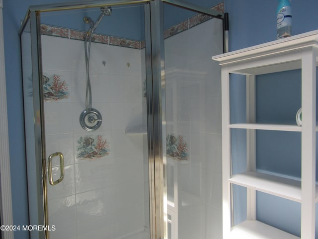 bathroom featuring a shower with door