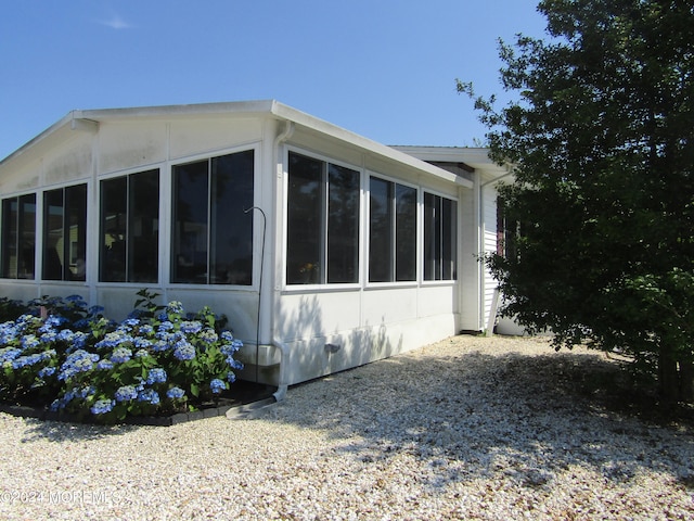 view of side of property featuring a sunroom