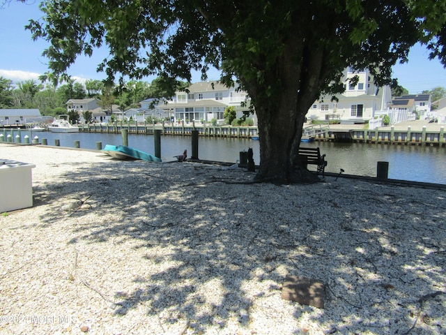 view of yard featuring a boat dock and a water view