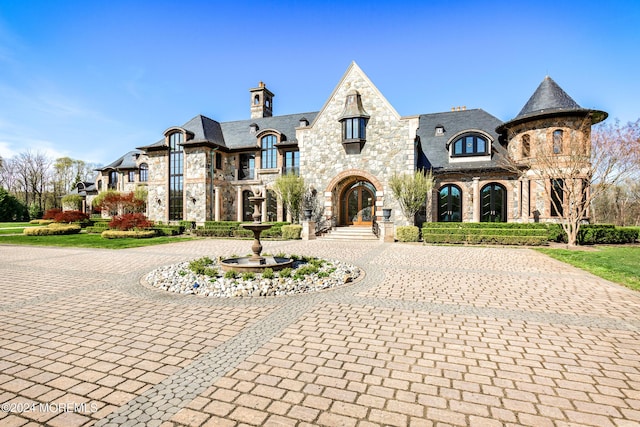 86 Montrose Rd, Colts Neck, NJ 07722 - french country style house with a high end roof, stone siding, a chimney, and curved driveway