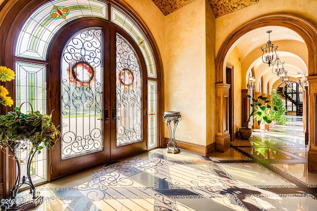 foyer with a notable chandelier and french doors