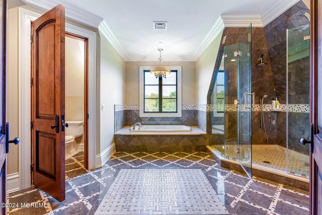 bathroom featuring ornamental molding, toilet, and shower with separate bathtub