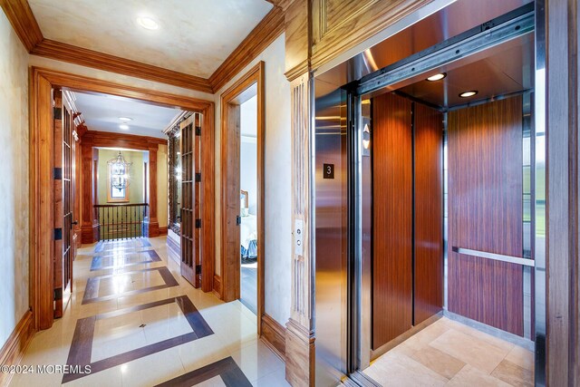 hall with a healthy amount of sunlight, ornamental molding, elevator, and light tile patterned flooring