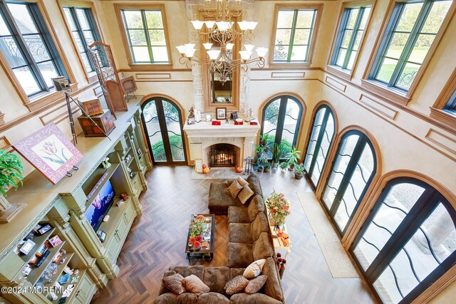 86 Montrose Rd, Colts Neck, NJ 07722 - living room with french doors, a high end fireplace, an inviting chandelier, and a high ceiling