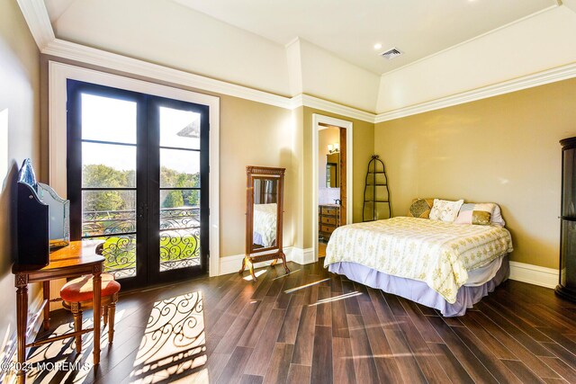 bedroom featuring dark wood-type flooring, ornamental molding, and french doors