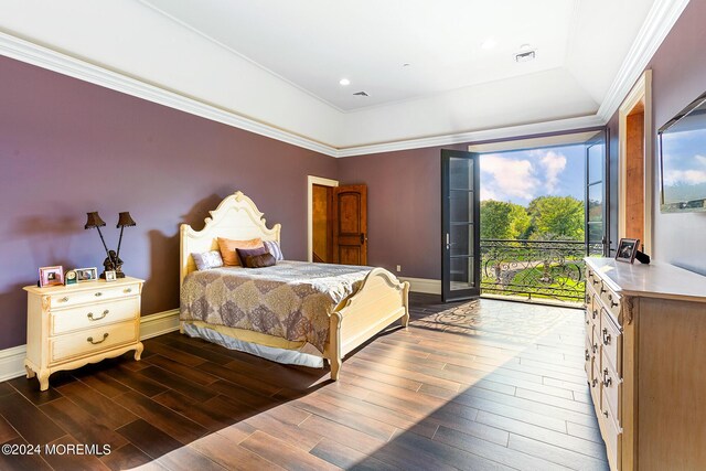 bedroom featuring dark wood-type flooring, crown molding, a raised ceiling, and access to outside