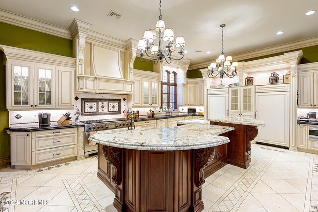 kitchen with a breakfast bar, a center island, cream cabinetry, and high quality appliances