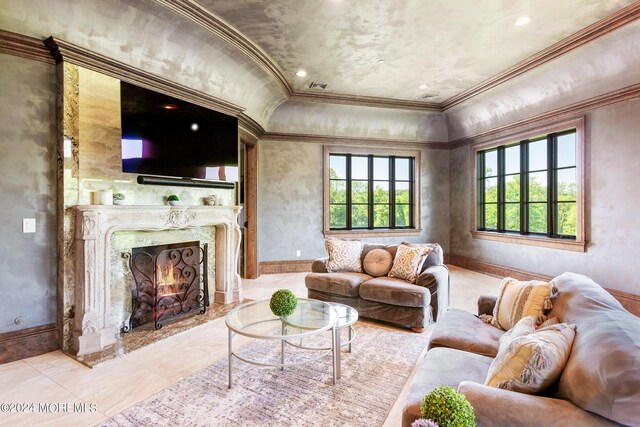 living room with a fireplace and ornamental molding