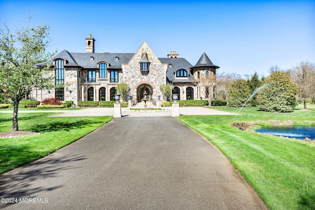 86 Montrose Rd, Colts Neck, NJ 07722 - french country inspired facade with stone siding, aphalt driveway, a chimney, a front yard, and a high end roof