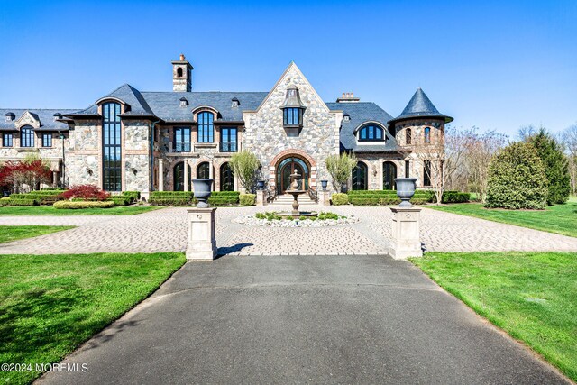 french country home with a front lawn