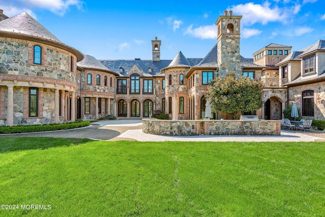 86 Montrose Rd, Colts Neck, NJ 07722 - view of front facade featuring a chimney, a patio, a high end roof, and a front lawn