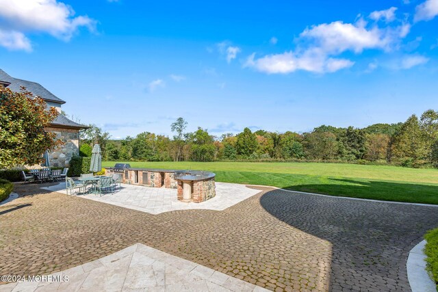 view of patio / terrace featuring an outdoor fire pit