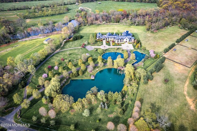 drone / aerial view featuring a rural view and a water view