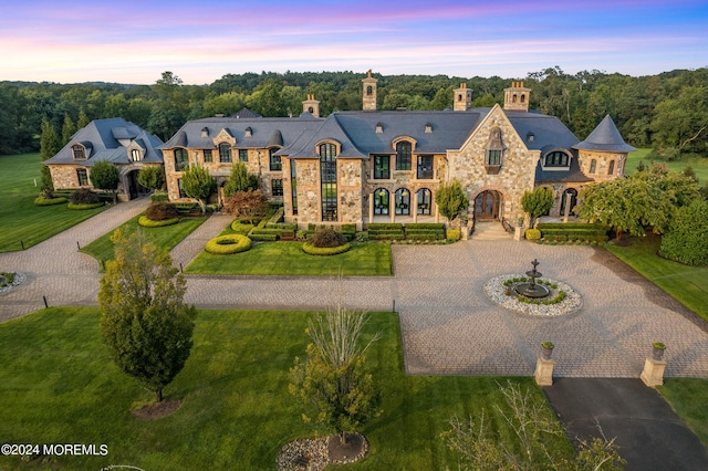 86 Montrose Rd, Colts Neck, NJ 07722 - french country style house with stone siding, curved driveway, and a lawn