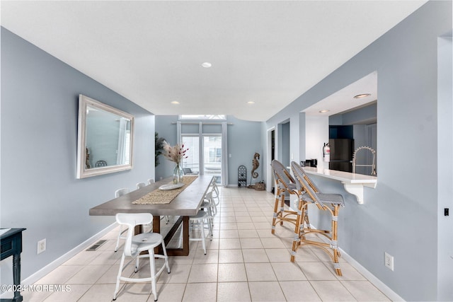 tiled dining area with sink