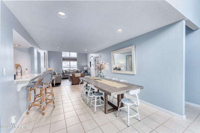 dining space with light tile patterned floors, baseboards, and recessed lighting