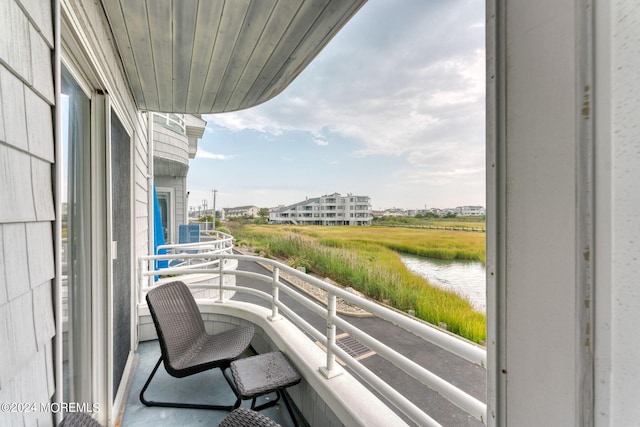 balcony featuring a water view