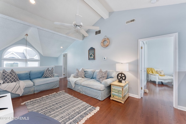 living area featuring visible vents, beamed ceiling, baseboards, and wood finished floors