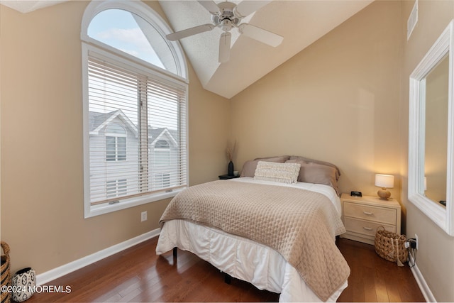 bedroom featuring baseboards, visible vents, dark wood finished floors, a ceiling fan, and lofted ceiling