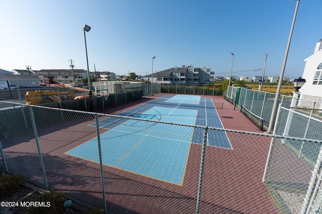 view of tennis court with fence