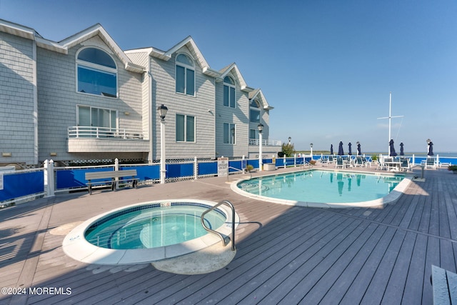 pool with fence and a community hot tub