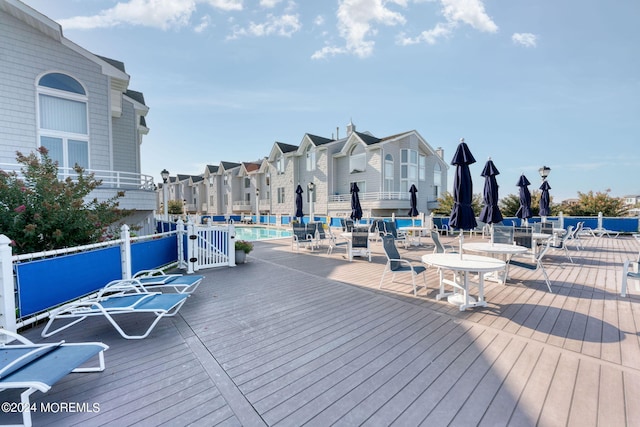 wooden terrace featuring a community pool