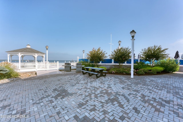 view of property's community with a gazebo and a water view